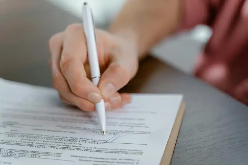 person signing a contract to buy or sell a home in Central Texas